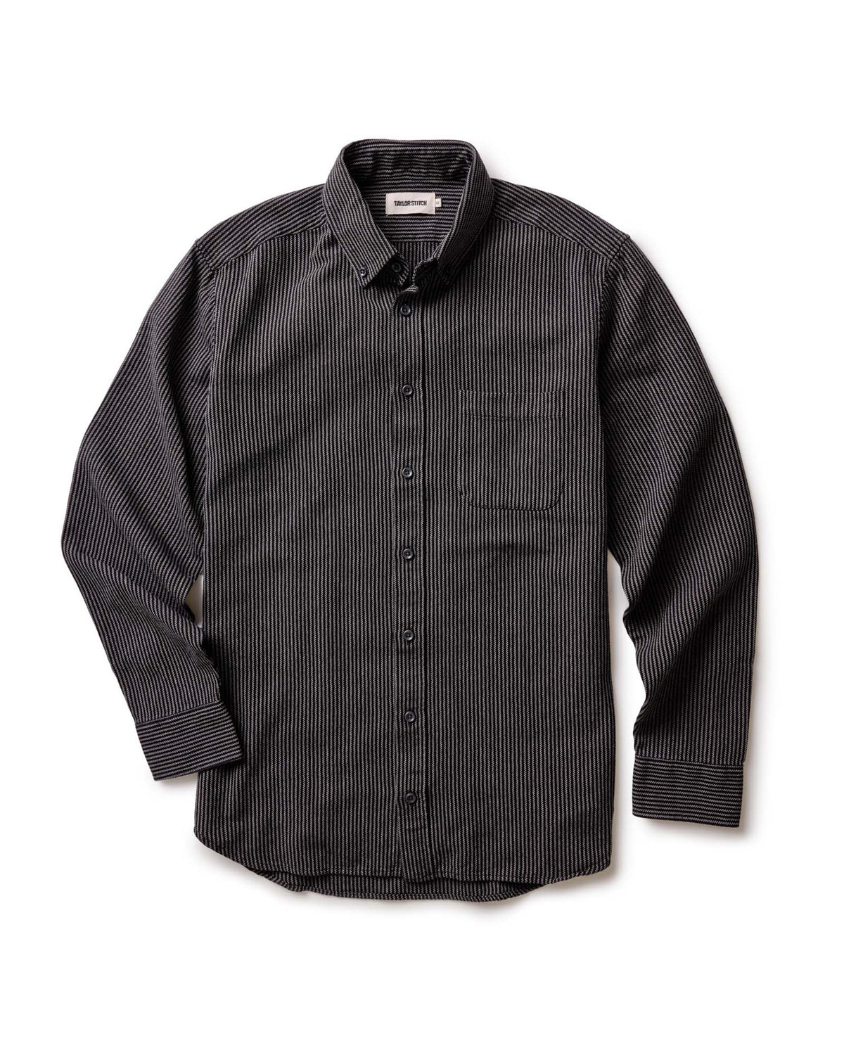The Jack in Roped Black Indigo by Taylor Stitch, flat lay front view showing full shirt silhouette, button-down collar, chest pocket, and long sleeves