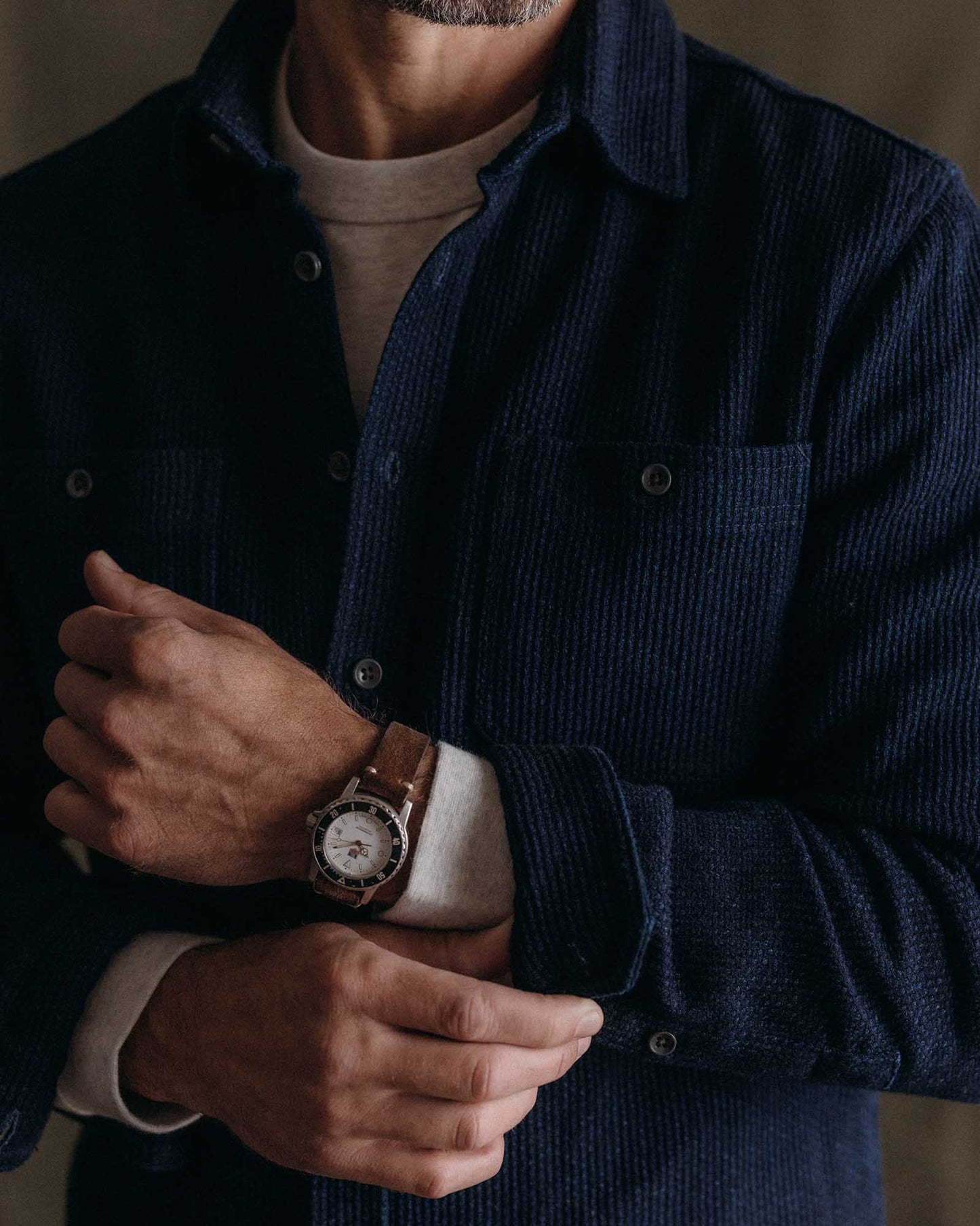 Model wearing Taylor Stitch Utility Shirt in Rinsed Indigo Sashiko, full front view showing deep rinsed indigo sashiko weave, spread collar, dual button-through chest pockets, and relaxed straight silhouette
