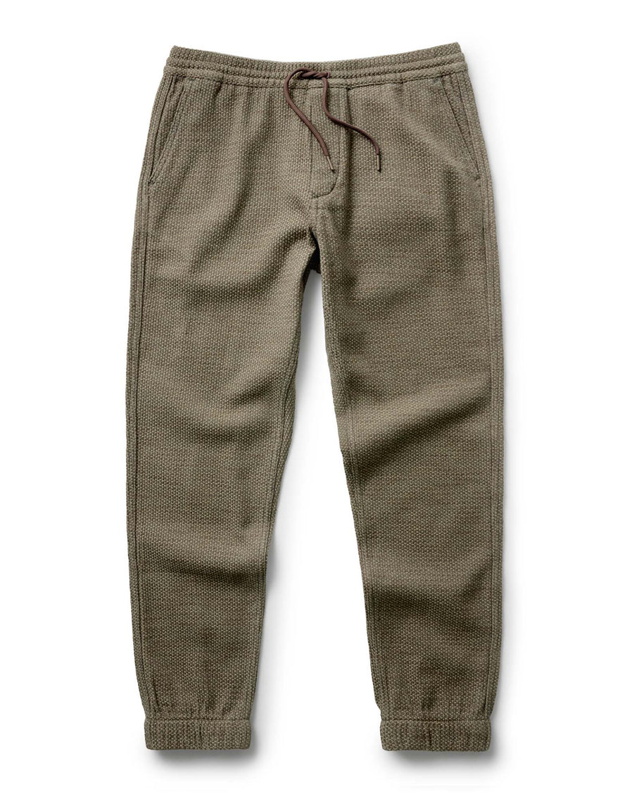 Taylor Stitch Après Ski Pant in Cypress Sashiko, flat lay showing full length olive green sashiko-woven jogger with drawcord waist and elastic cuffs
