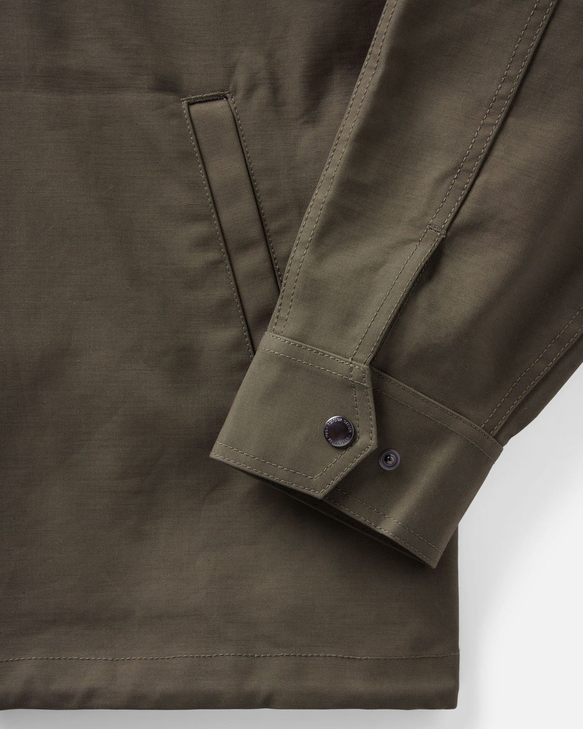 Close-up of the Hatteras Anorak’s adjustable snap cuff, double stitching, and welt pocket opening.
