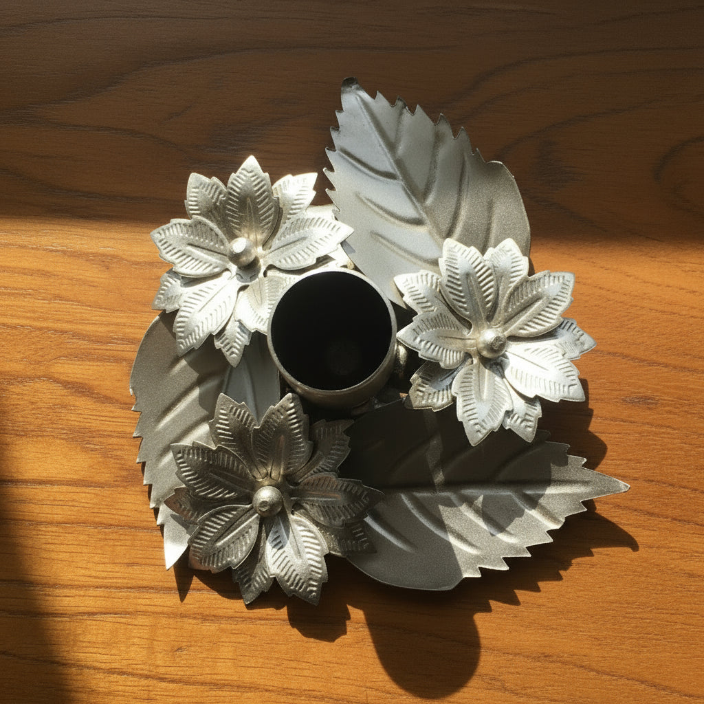 Decorative metal object with floral designs on a white background