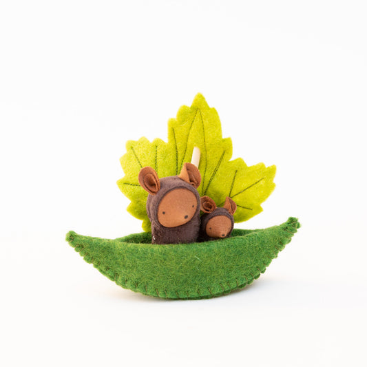 Fairy Shadow Critters in Leaf Sailboat in chocolate mice, product view against white background, showing a large dark brown felt mouse critter and a small dark brown felt mouse critter sitting together in a curved green felt leaf boat, with a hand-embroidered yellow-green felt maple leaf as the sail
