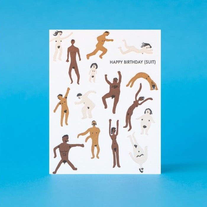 A letterpress printed greeting card with various illustrated human figures in a suit, with the text 'HAPPY BIRTHDAY (SUIT)' at the top. The card is displayed against a blue background.