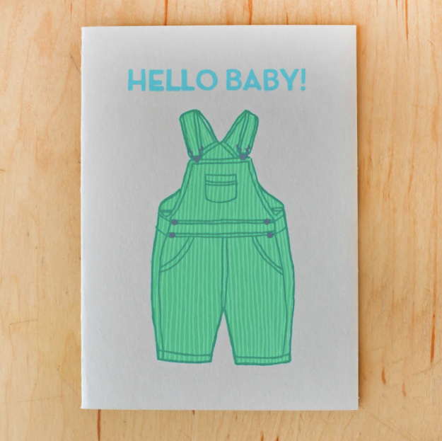 gold teeth brooklyn hello baby card laydown top view on wooden background